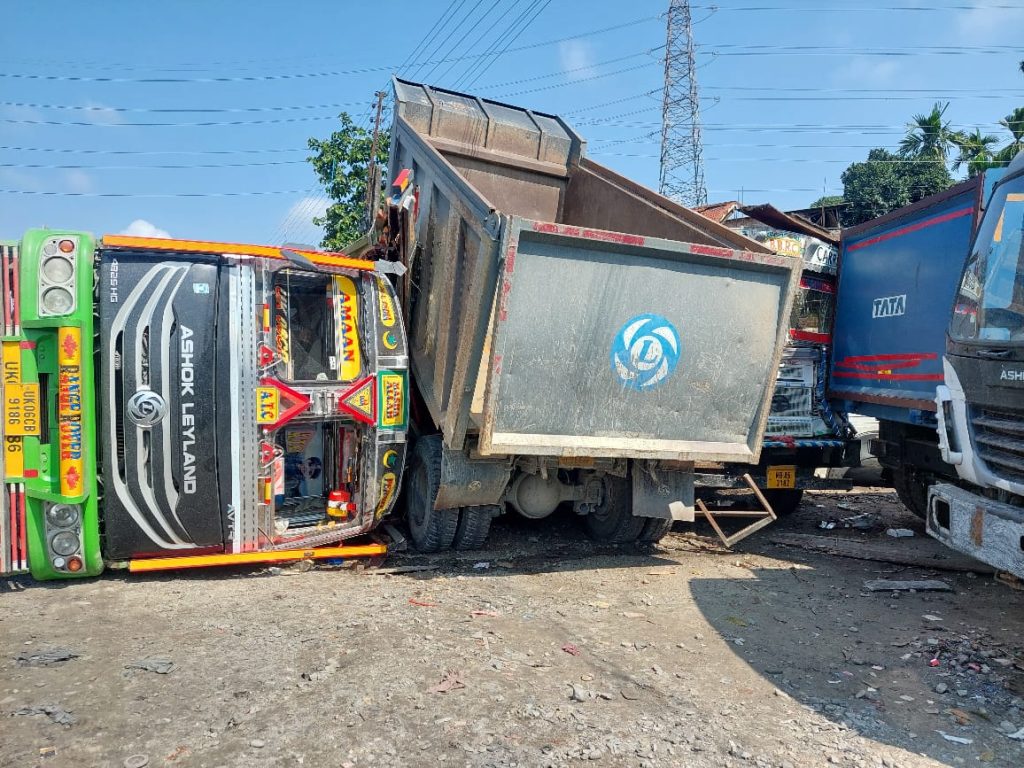 Rampant goods-laden lorry overturned in front of garage in Fulbari